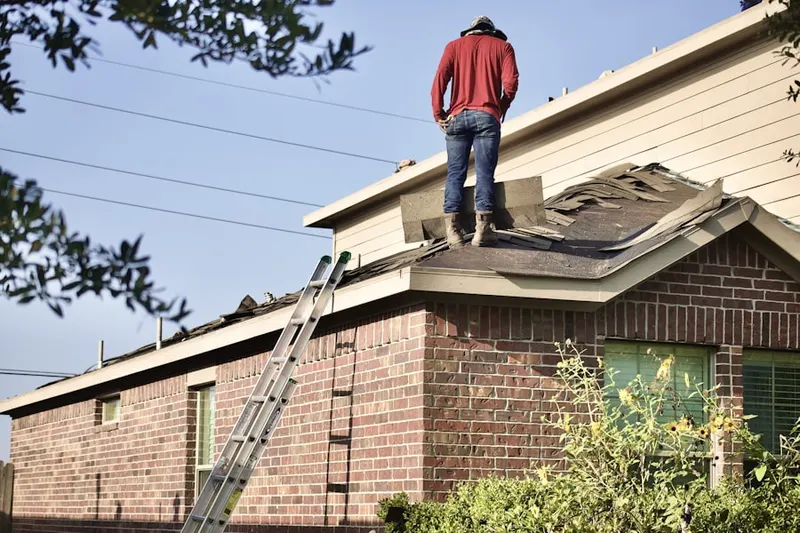 Professional roofer working on a residential roof in Courtland Park